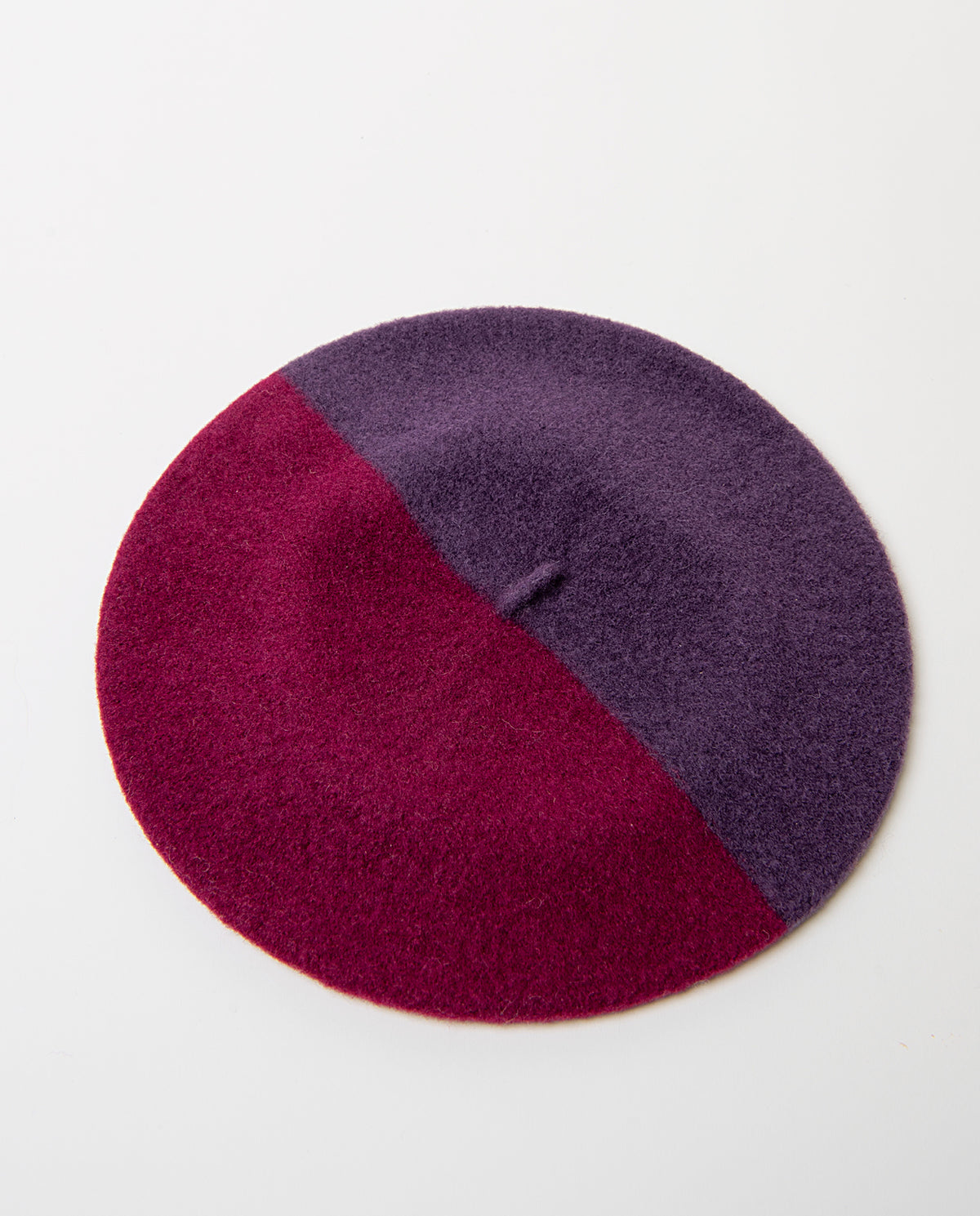 Soft, warm wool beret in a two-tone cherry and purple design split on the diagonal. Classic round shape with a little stalk on top.Dia: 60cm