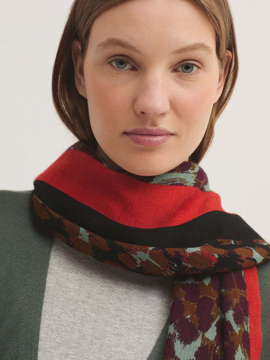 Rectangular wool scarf with patch leopard print in brown, light grey, burgundy colors and 2 intense red and black stripes