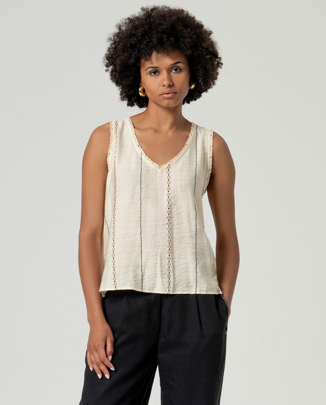 Ecru sleeveless with black embroidered prints viscose top.