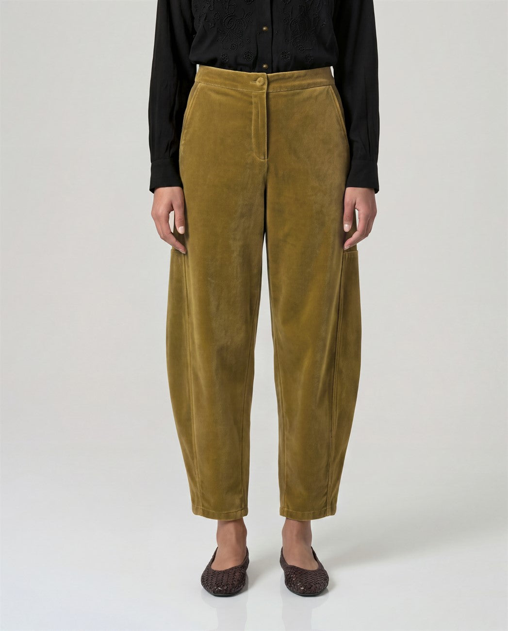 Cotton velvet mustard trousers with a rounded barrel leg and a high waist. Button-and-zip fastening, pockets and a soft, warm feel.