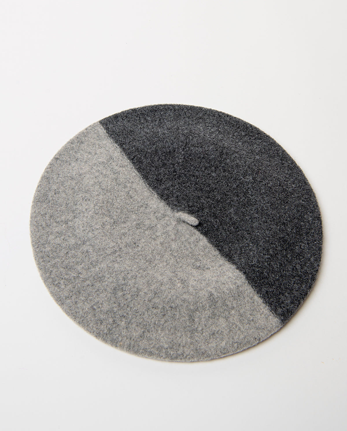 Soft, warm wool beret in a two-tone dark grey and light grey design split on the diagonal. Classic round shape with a little stalk on top.Dia: 60cm