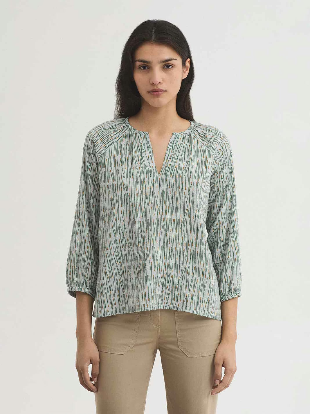 Pine Needles green with dark yellow prints in ecru background color blouse,round neck with opening and gathers,raglan puff sleeves with elasticated cuffs.