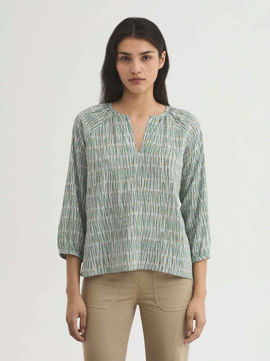 Pine Needles green with dark yellow prints in ecru background color blouse,round neck with opening and gathers,raglan puff sleeves with elasticated cuffs.