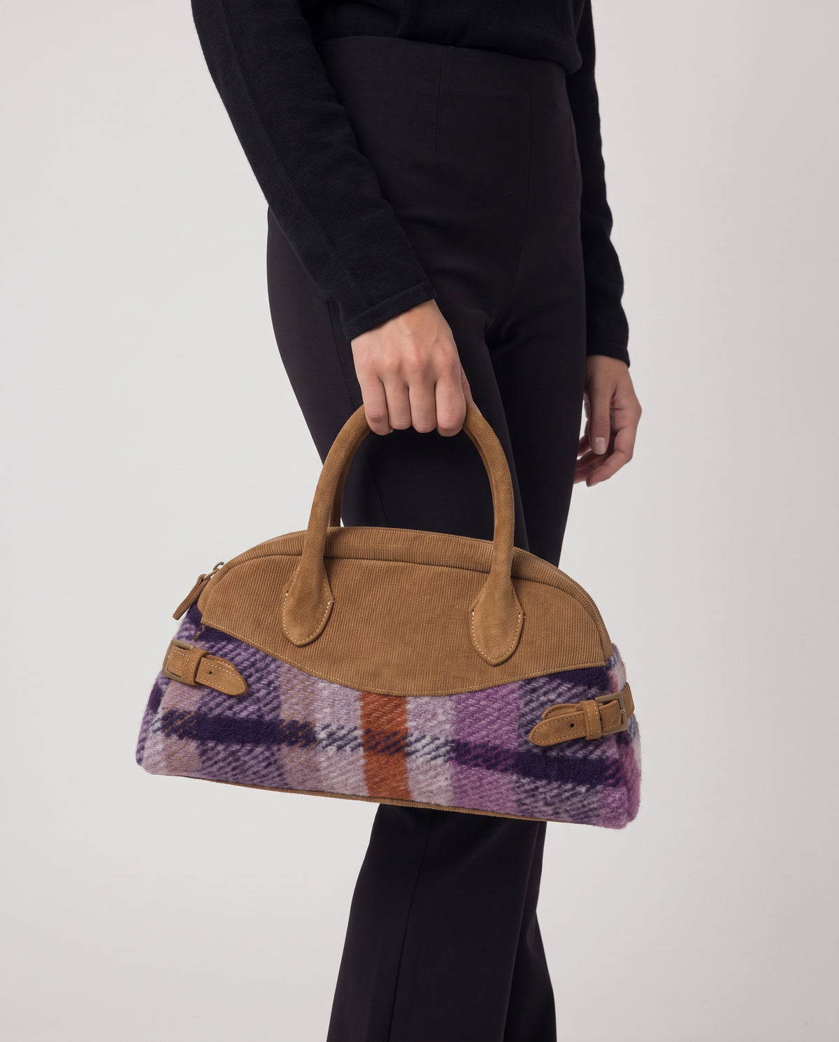 Elongated bowling purple and camel bag with double handles and an adjustable crossbody strap. Body in warm, textured wool check fabric, mixed with smooth details and side buckles. Inner open pocket and zip pocket, 32cm x 17cm x 12cm