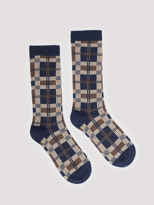 Pair of plaid patterned socks with navy blue, beige and ecru colors