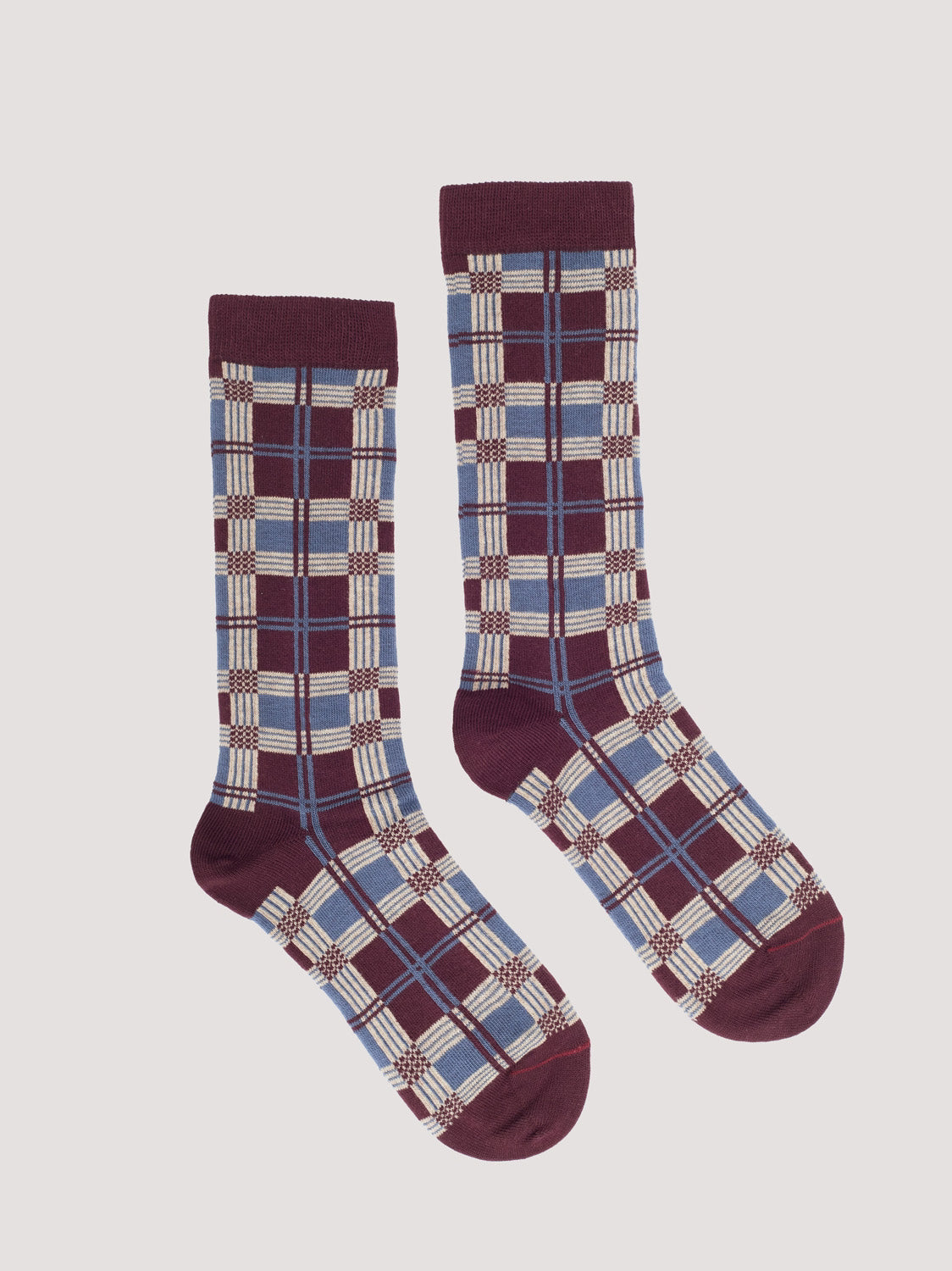 Pair of plaid patterned socks with chestnut, light blue and ecru colors 