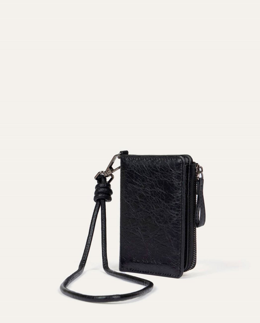 Black compact coin purse type wallet in synthetic leather with natural wrinkled texture. Zipper closure with matching knot puller and handmade knot strap detail. Interior with multiple card slots and large main compartment. 