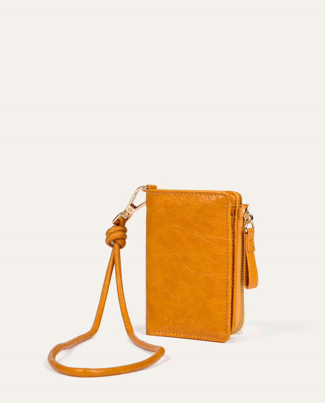 Orche compact coin purse type wallet in synthetic leather with natural wrinkled texture. Zipper closure with matching knot puller and handmade knot strap detail. Interior with multiple card slots and large main compartment. 