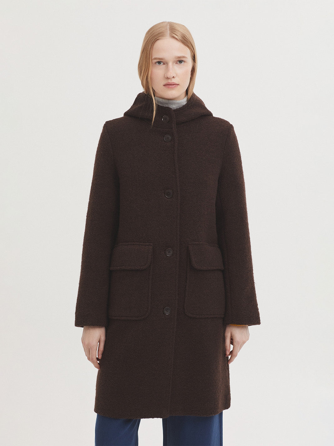 Brown midi coat oat in 100% boiled wool fabric, with hood, button front and patch pockets with flap. Lined. 60% Polyester, 40% Wool