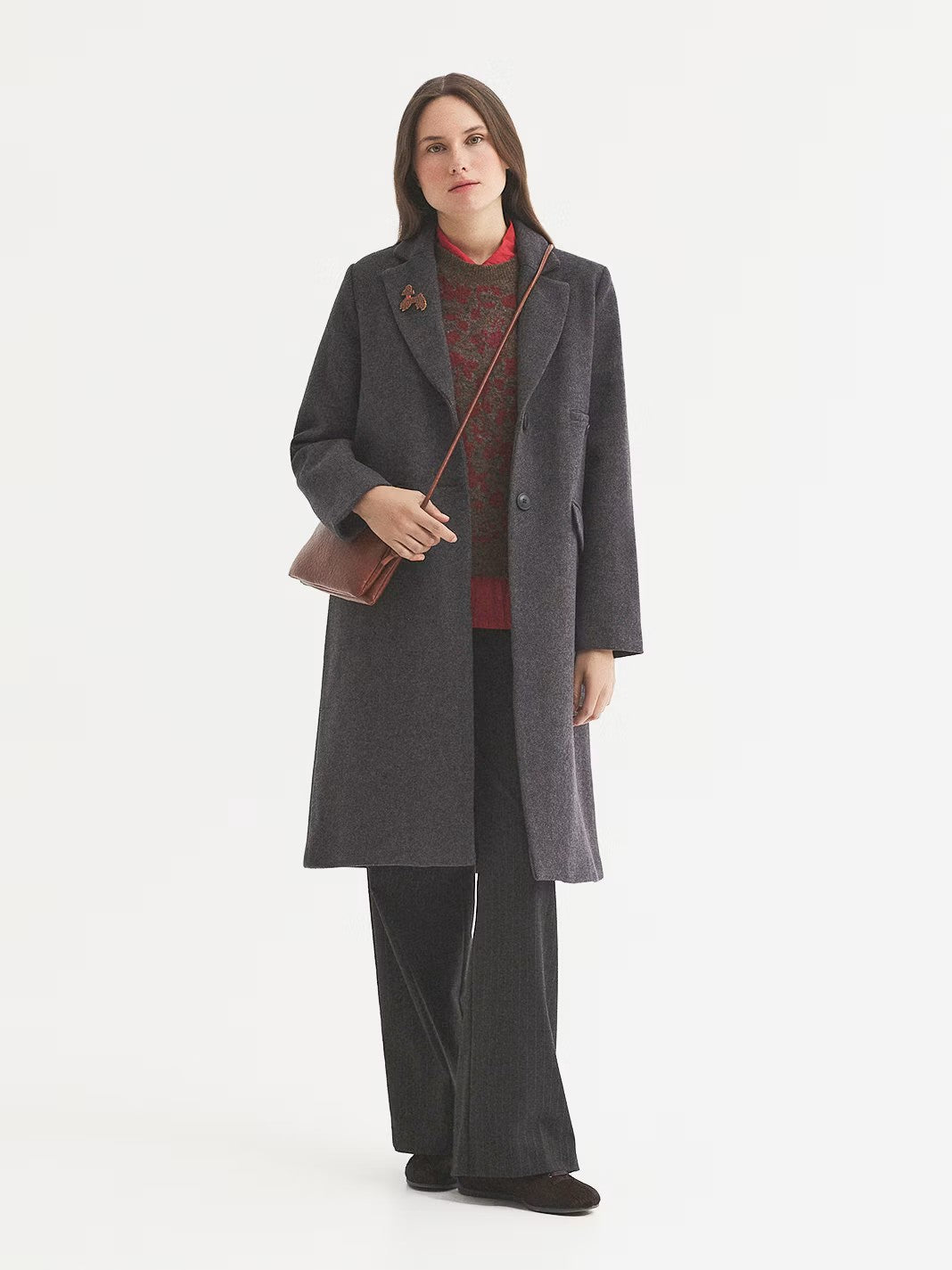 Tailored grey coat in wool blend twill fabric, designed with notch lapels, button front and hacking pockets and a piped pocket with button. With tailored sleeves, vent at back, inner lining and contrast piping.