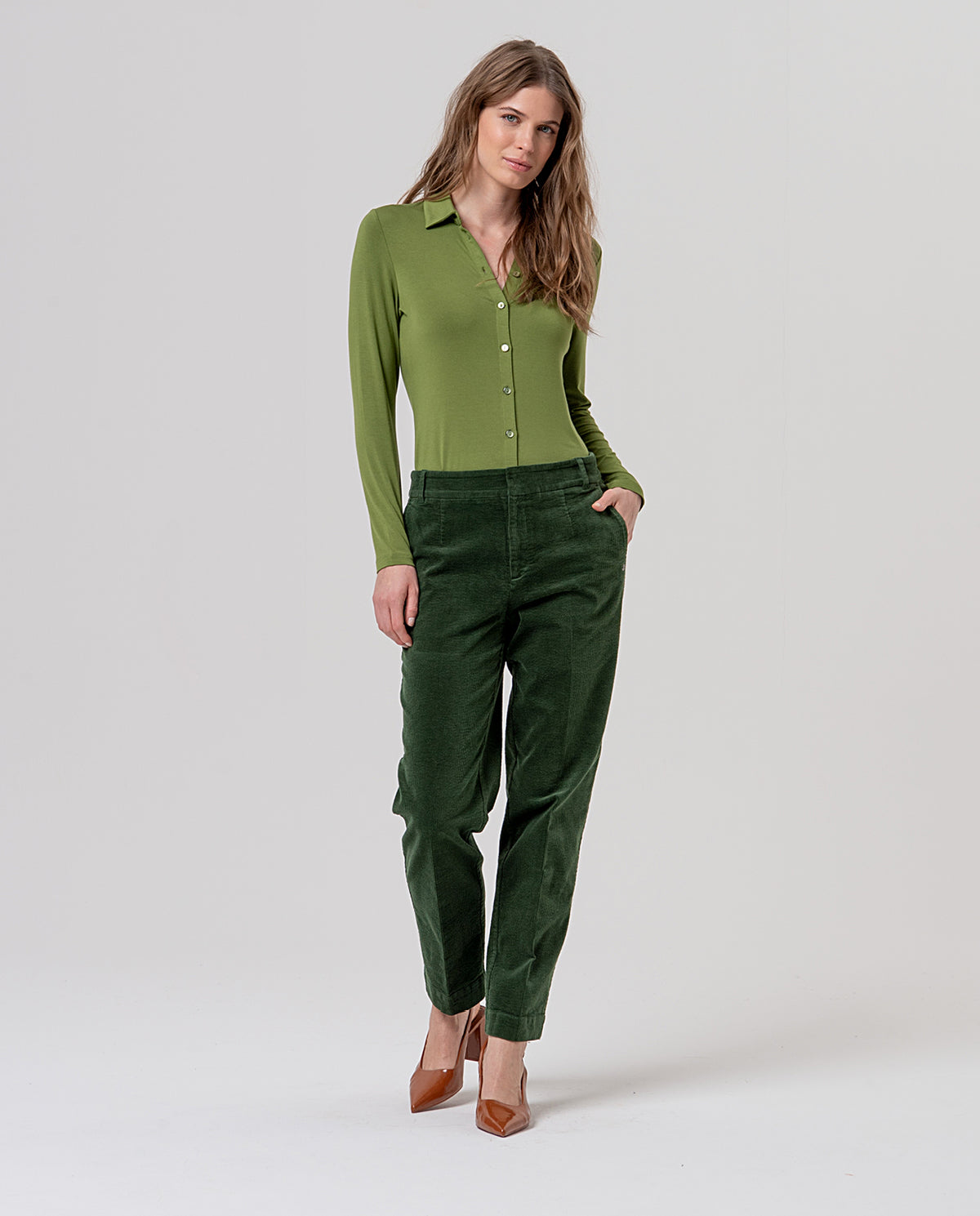 Khaki, straight-leg chino trousers with mid rise, belt loops and pockets. Fine cotton corduroy, soft with a ribbed texture. Plain, with a clean, flattering drape. Comfort.