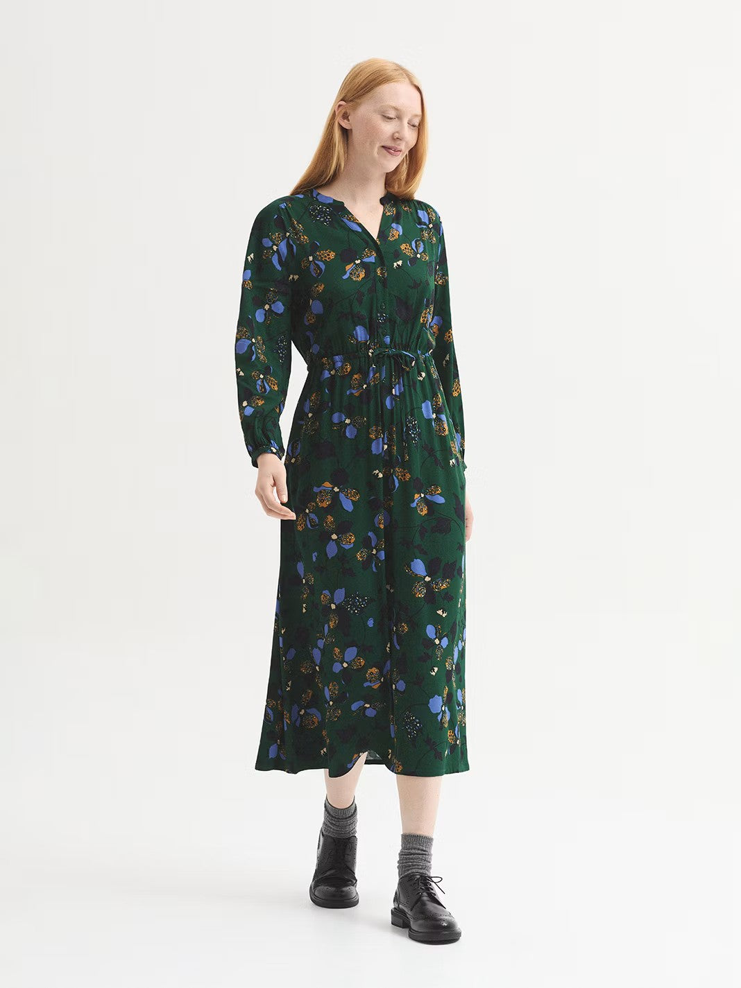 Midi green dress in viscose crêpe with Geometric Flowers print in camel and light blue colors, designed with an open mandarin collar, button front, concealed elasticated waistband and self-fabric tie waist, side pockets, flared skirt and raglan sleeves with vent, cuff and button.