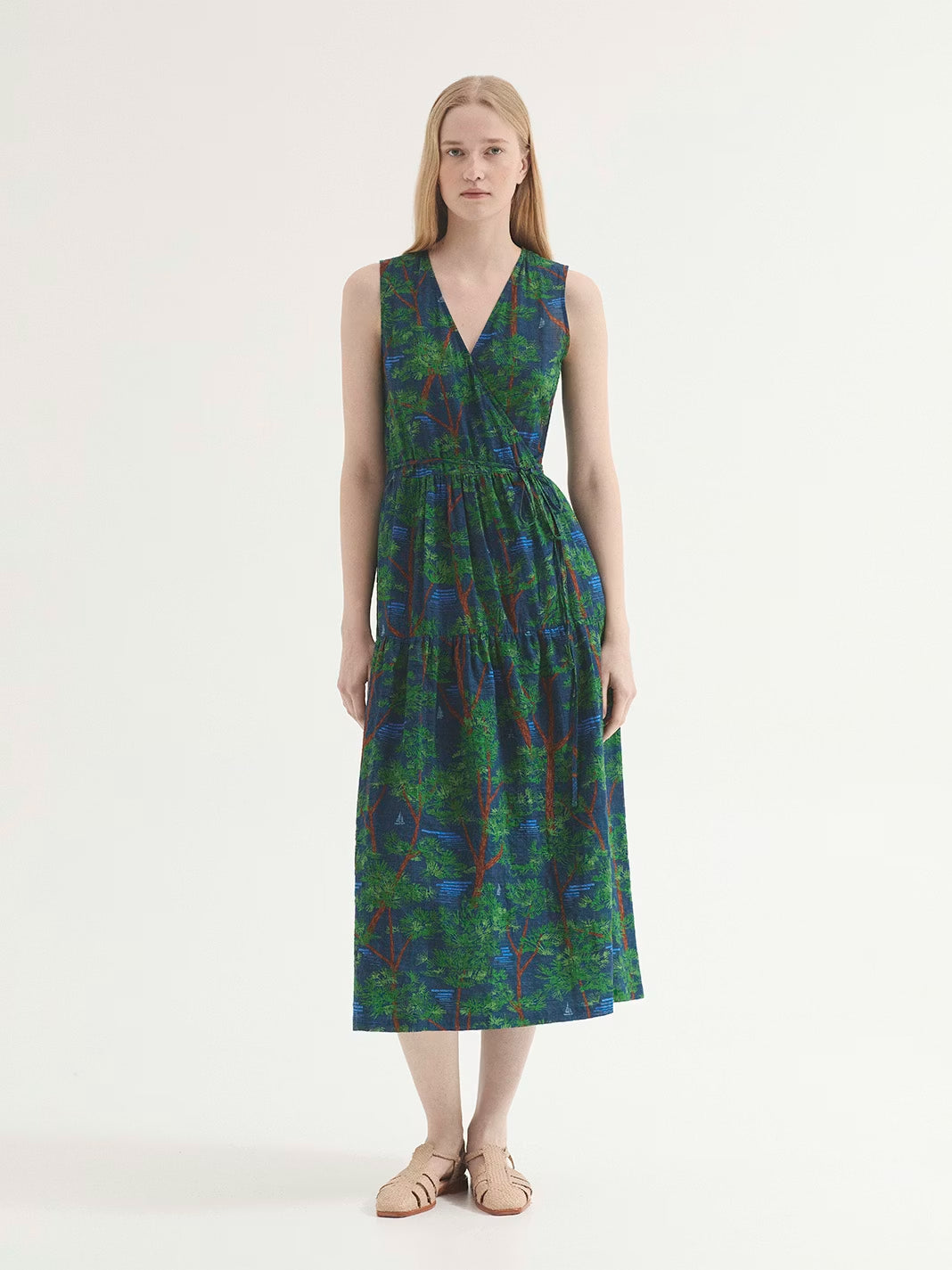 Blue Pine Trees print dress, with brown and green pine trees, wrap model with self-fabric tie waist for closing, V neck, Natural waist and ruffle skirt, side pockets, 50% Viscose,50% Cotton.