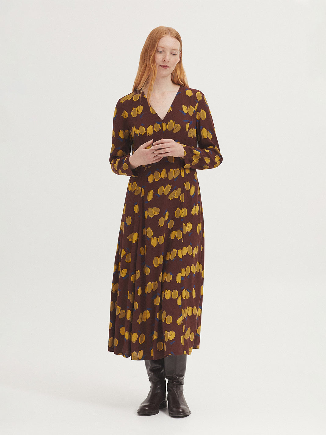 Dress in chestnut sustainable viscose crêpe fabric with dark yellow Tulips print, V neck, natural waist and side seams, flared skirt.
