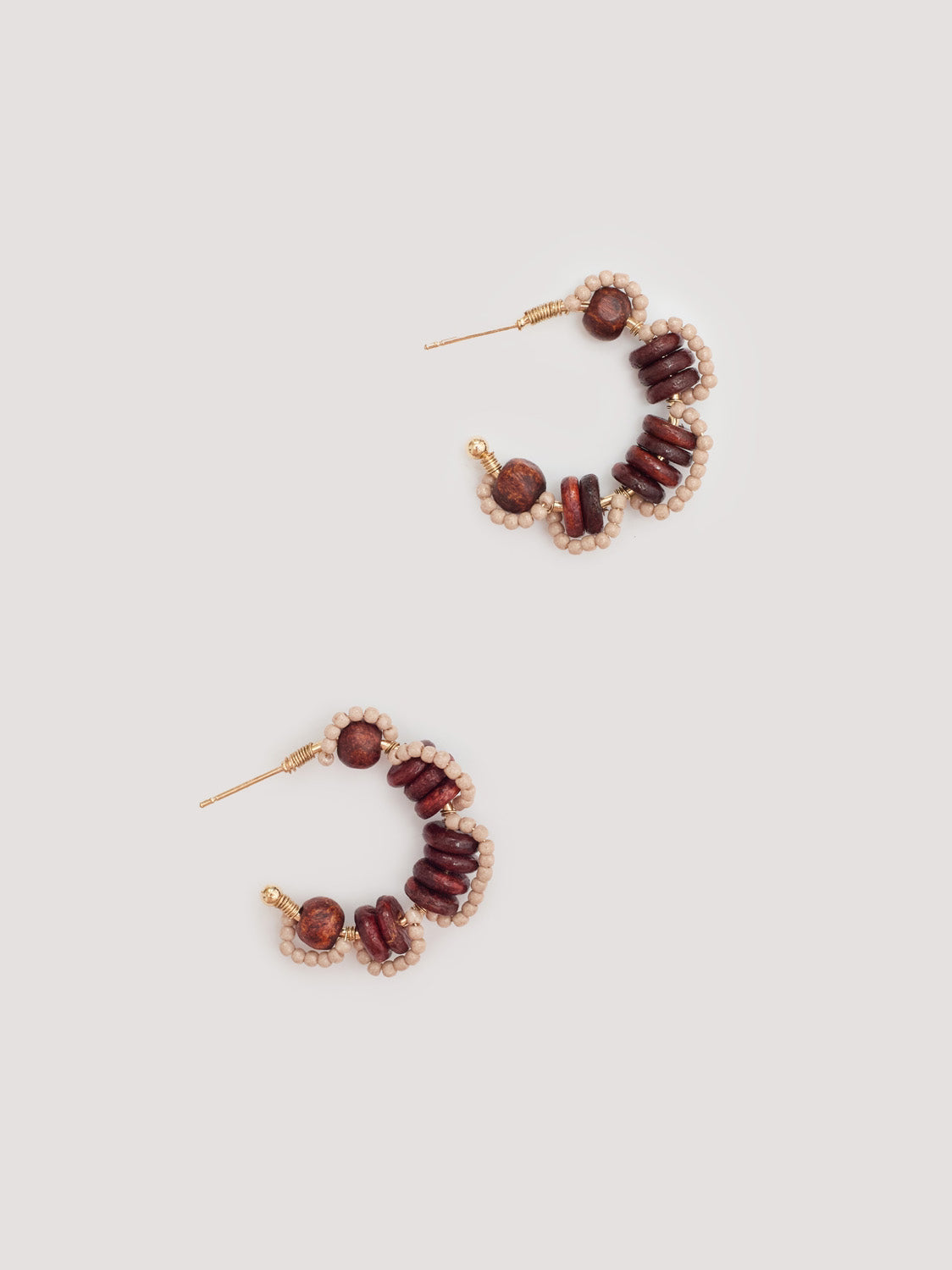 Pair of stone color beaded hoop earrings in a flower shape