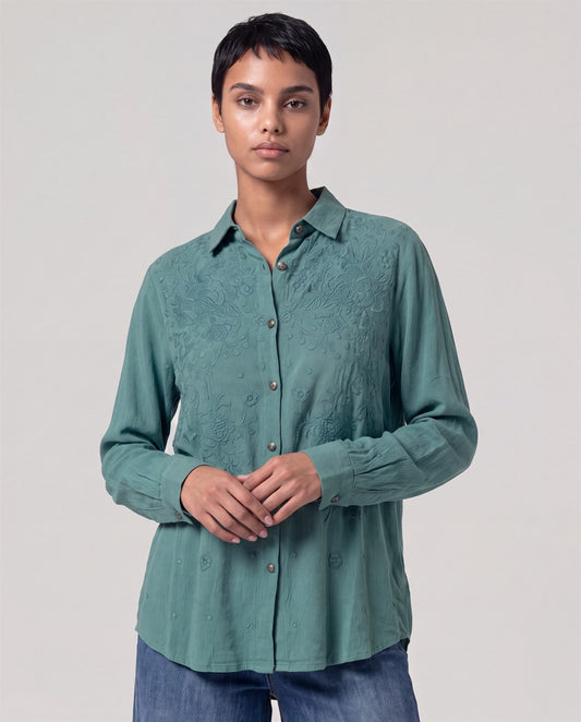 Long-sleeve powdery green shirt in soft viscose with a classic collar. Same color floral embroidery on the top and chest, metal buttons with detail and a light drape.