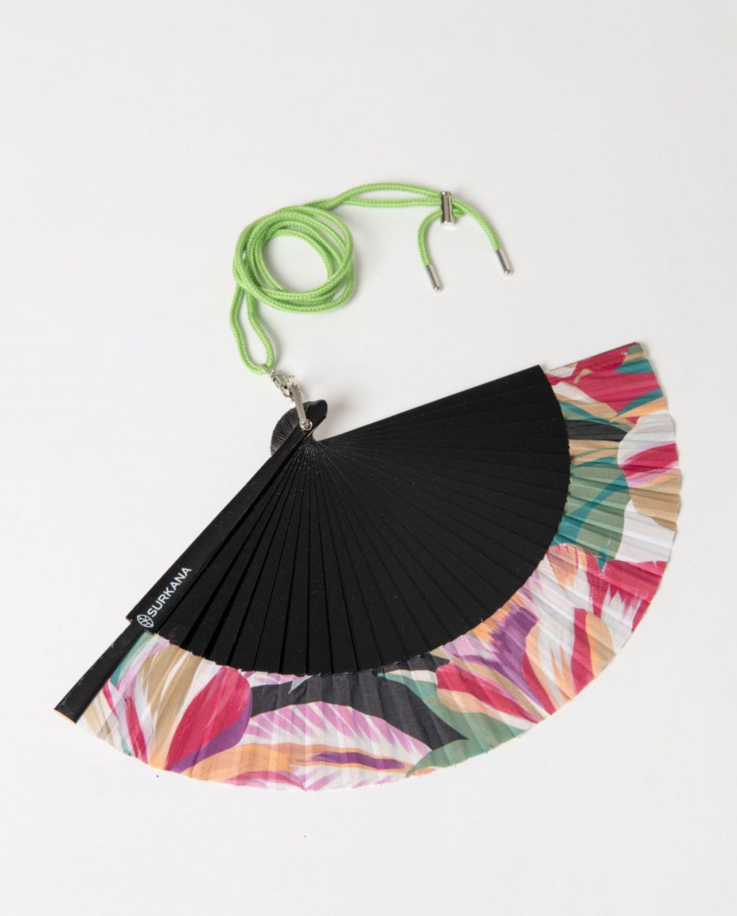 Colorful fan with a black center and multicolored edges, attached to a green strap.