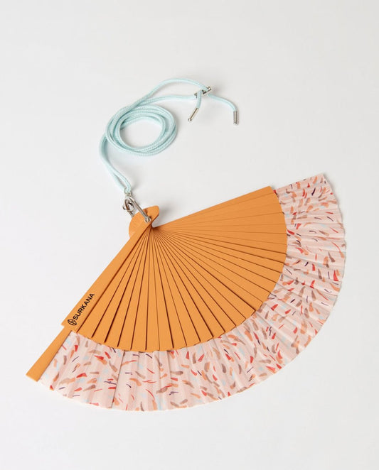 Hand fan with orange and patterned pink design and strap.