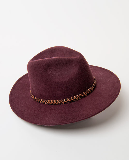 Wool maroon felt fedora with a wide brim and a pinched crown, cinched by a contrast braided cord. Adjustable inside cord.Designed in Barcelona. Dia: 55cm