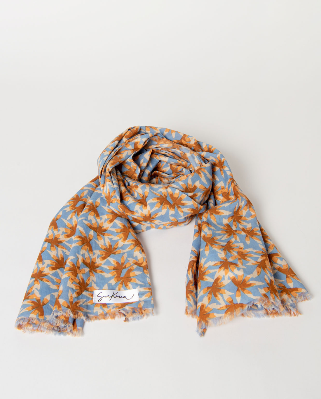 Rectangular dusty blue scarf made of lightweight fabric with tropical leaf print, short fringes at the ends, 100% cotton, 
180cm x 110cm