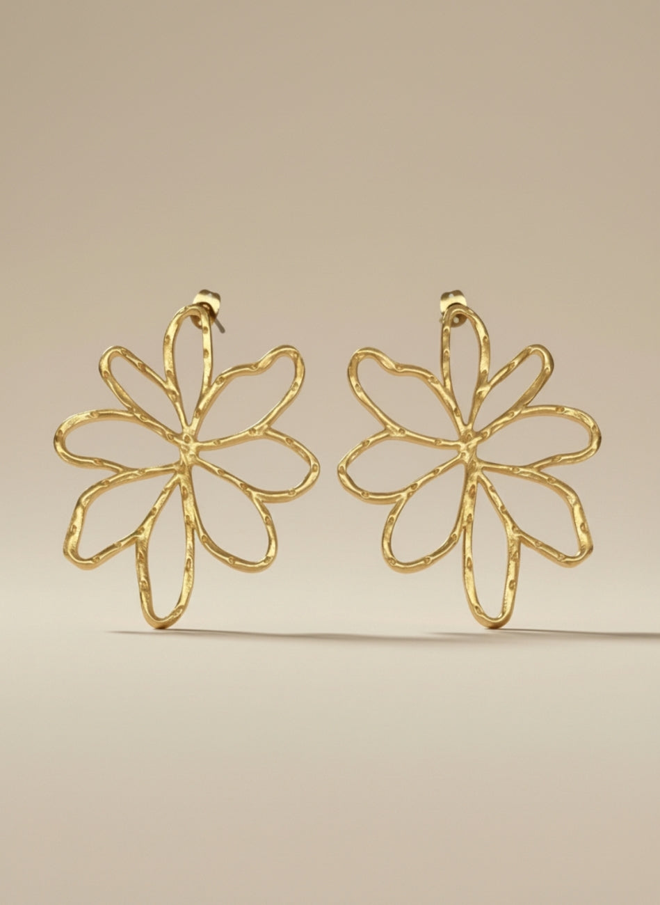 A pair of gold-tone flower-shaped earrings with a textured, hand-drawn outline finish, from rhodium with antique gold plating