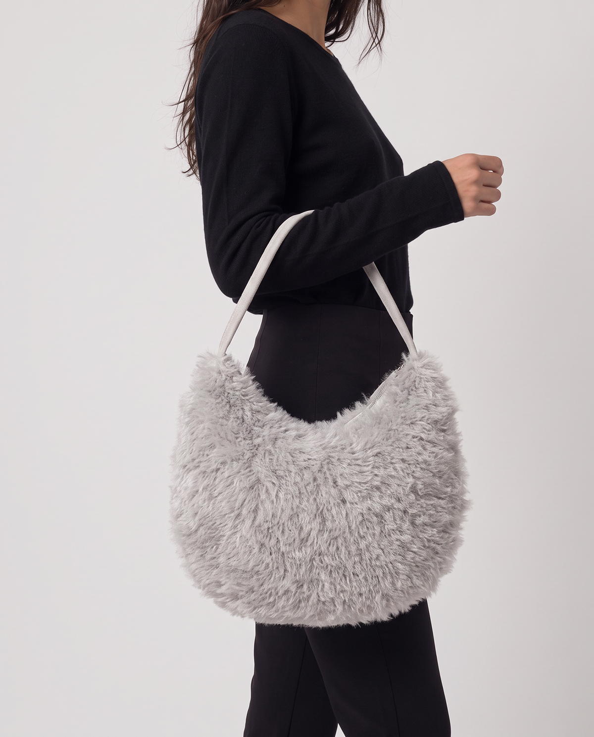 Shoulder bag grey in long-pile faux fur with a plush feel. Enveloping half-moon silhouette with a thin strap and zip closure, 34cm x 24cm x 10cm