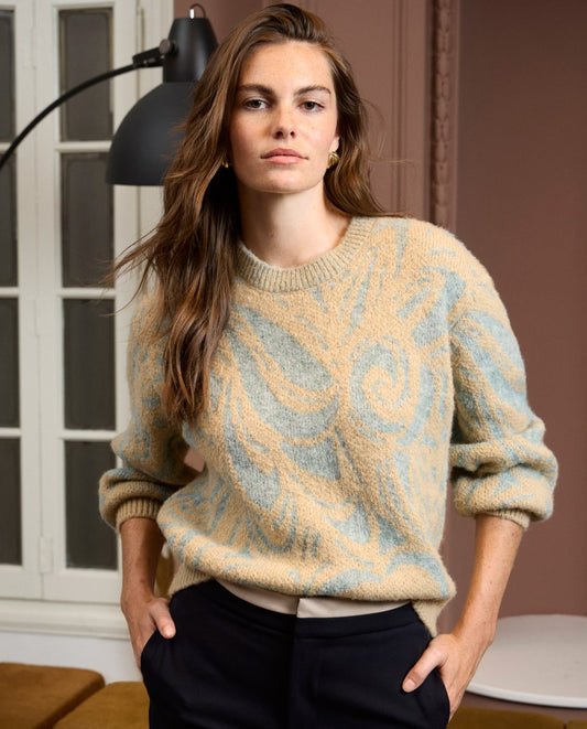 Chunky light blue and beige knit sweater with jacquard swirl design, in 50% Polyester, 30% Wool, 20% Recycled Polyester.