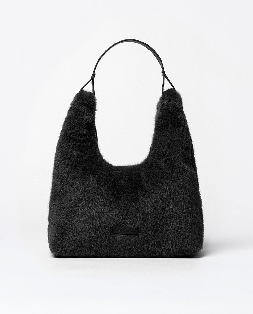 Large shopper shoulder faux fur black bag with  two compartments: one zippered and one open. Zip closure. Lining.