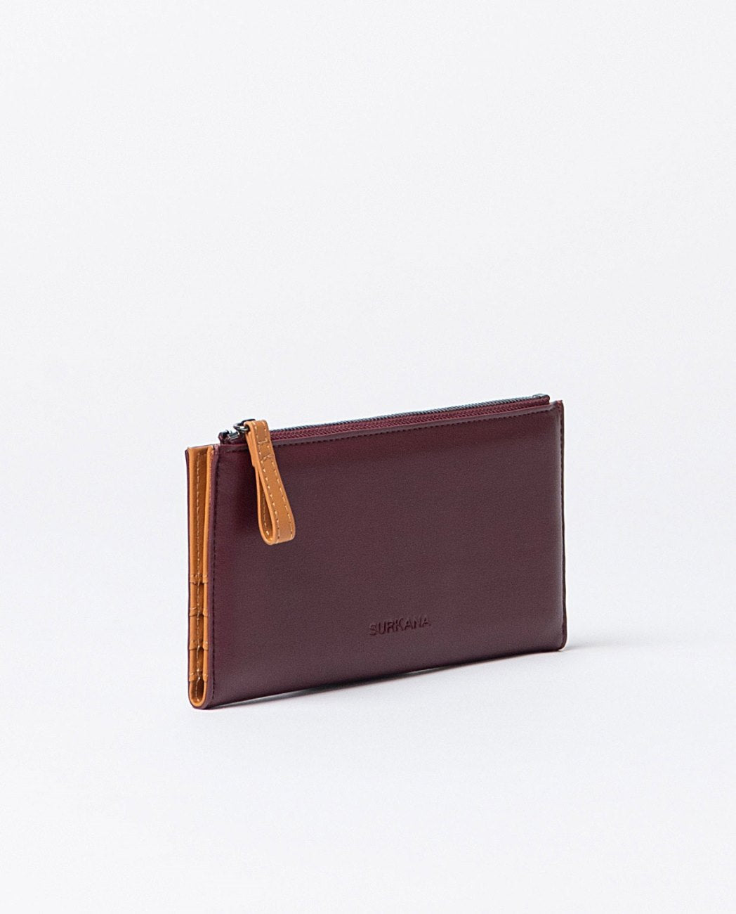 Large compact bi-color wallet in bordeaux and orange faux leather, includes compartments for cards, a zippered pocket and snap buttons closure.