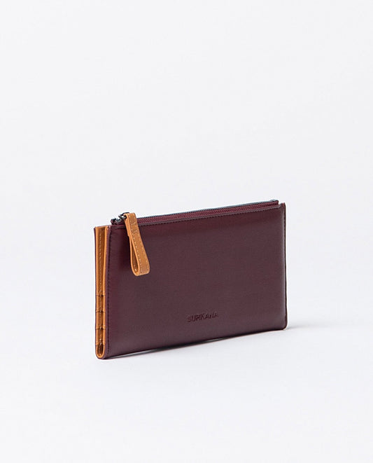 Large compact bi-color wallet in bordeaux and orange faux leather, includes compartments for cards, a zippered pocket and snap buttons closure.