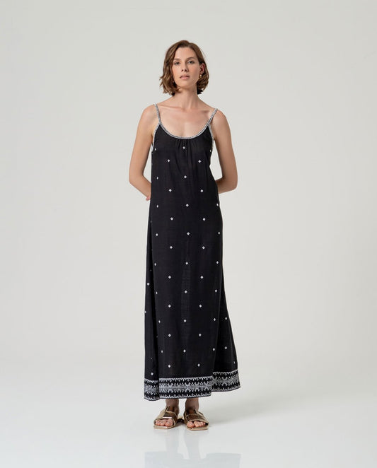 Black long dress with thin straps and slightly rounded straight neckline with decorative detail around the neckline and subtle embroidery distributed on the front.