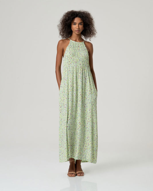 Long printed dress with thin straps and round neckline with ruching in light green color.