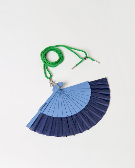Blue and navy foldable hand fan with a strap.
