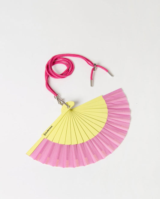 Pink and lime foldable hand fan with a strap.