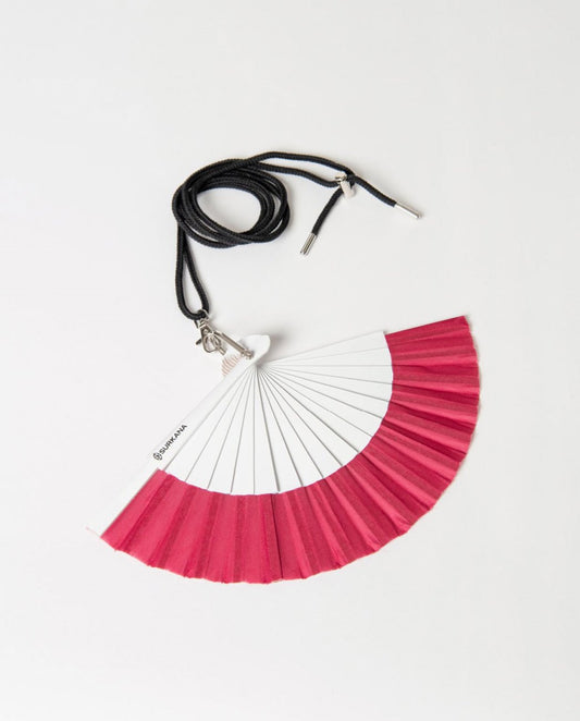 Fuchia and white foldable hand fan with strap.