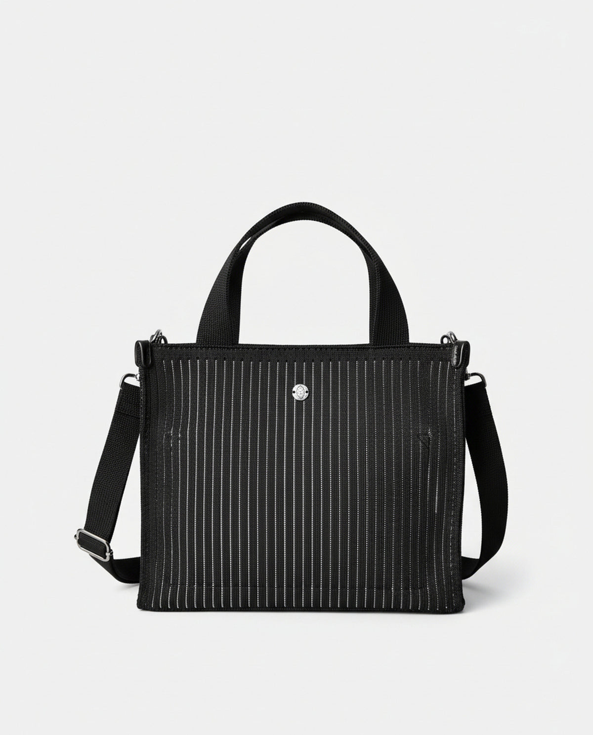 Mini black shopper in fine vertical striped knit, light and flexible. Double handles and adjustable crossbody strap, with a top closure and metal charm. Inner pocket. 24cm x 19cm x 6cm
