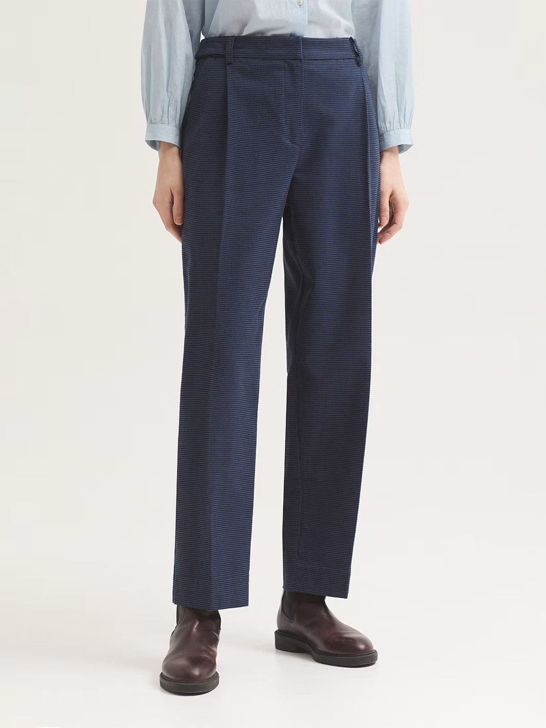 Trousers blue in houndstooth brushed cotton fabric. Featuring concealed metal hook, button and zip fastening at front, front slash pockets and back piped pockets, aside from belt loops and loops with buttons at the waist.