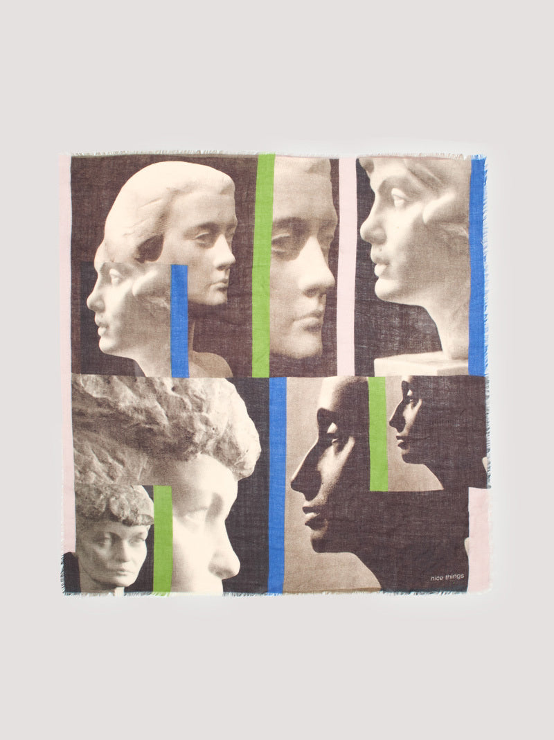 Square wool scarf, with statue heads print in dark grey, ecru colors and some intense blue and green stripes between.