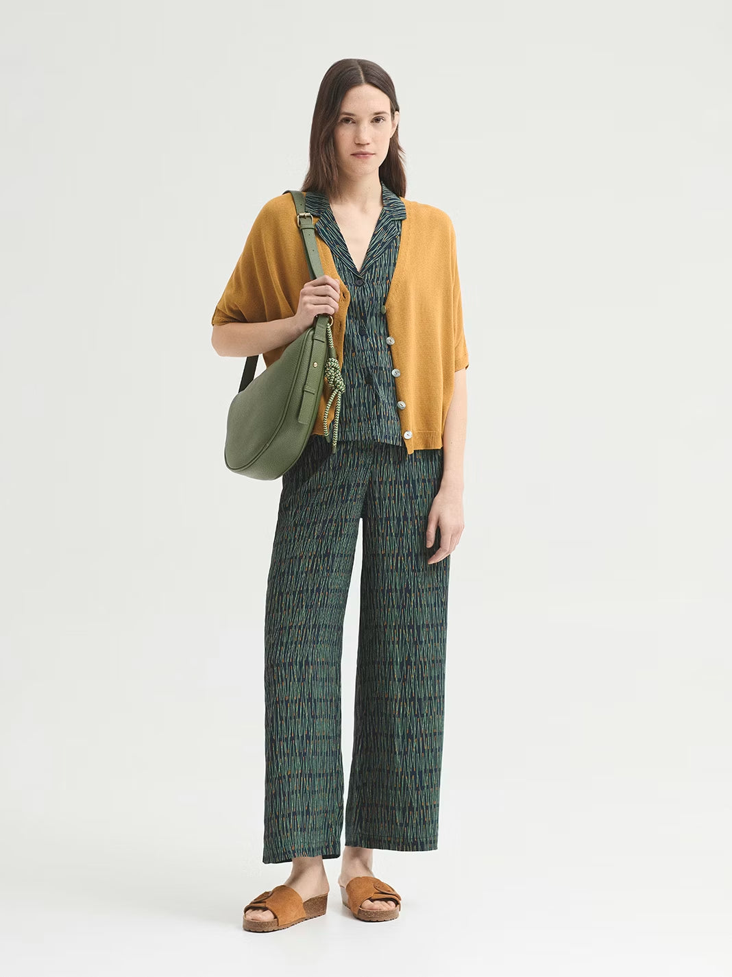 Flowy navy trousers made of viscose crêpe with Pine Needles print. Featuring a metal hook, concealed button and zip fastening. Concealed elasticated waist at back and wide leg.