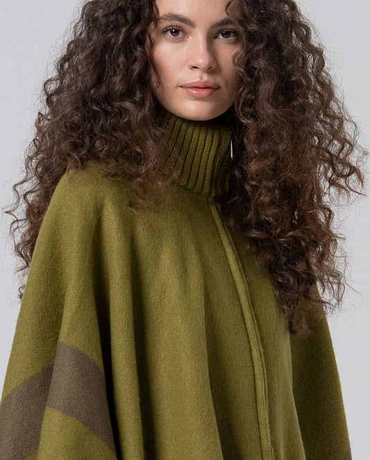 Wide cut knit light green poncho with zipper front closure and stand-up collar. It features a design with grey contrasting stripes
