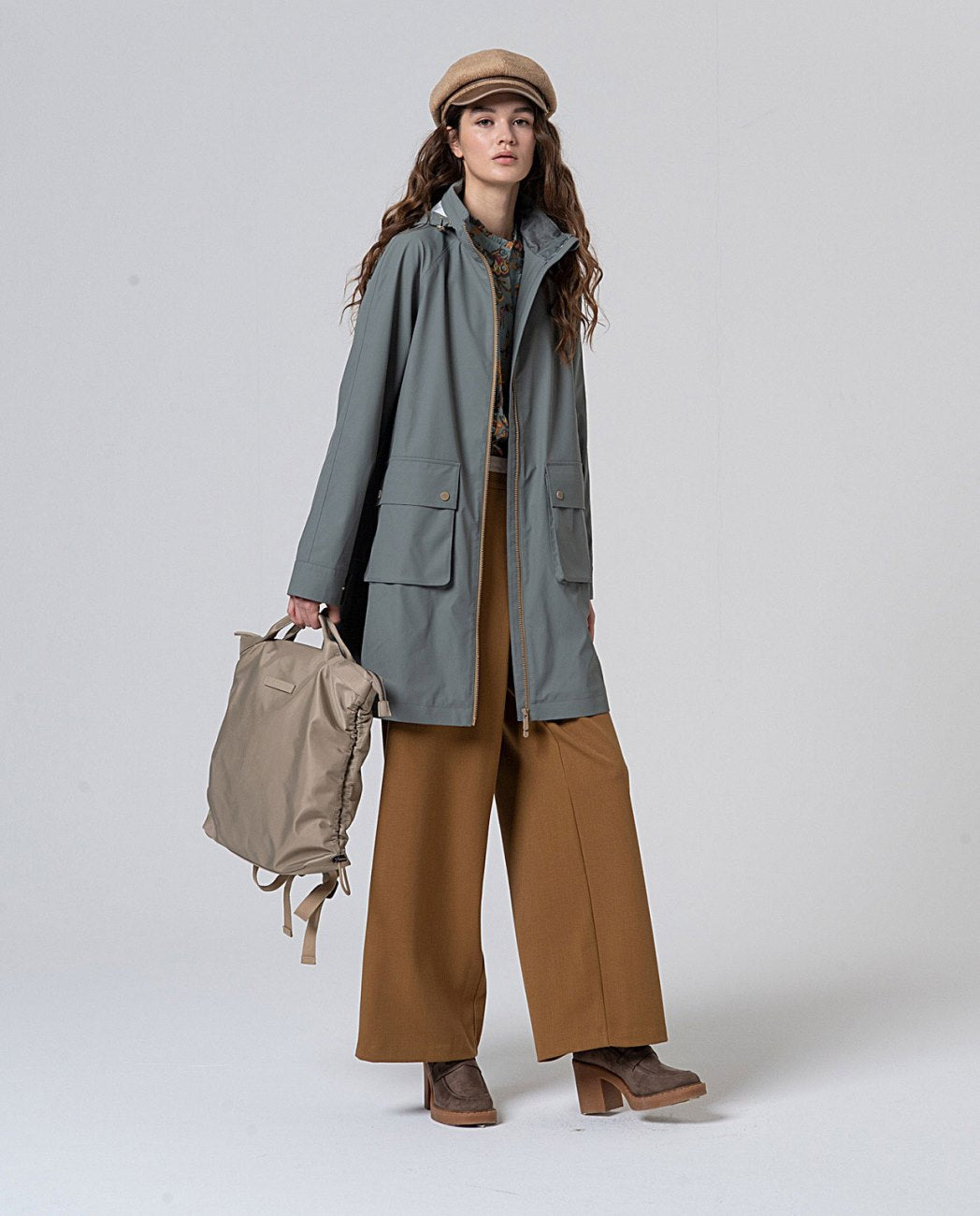 Straight cut khaki waterproof raincoat with hood, fleece-lined interior, zippered front closure and large flap pockets, in 100% polyester