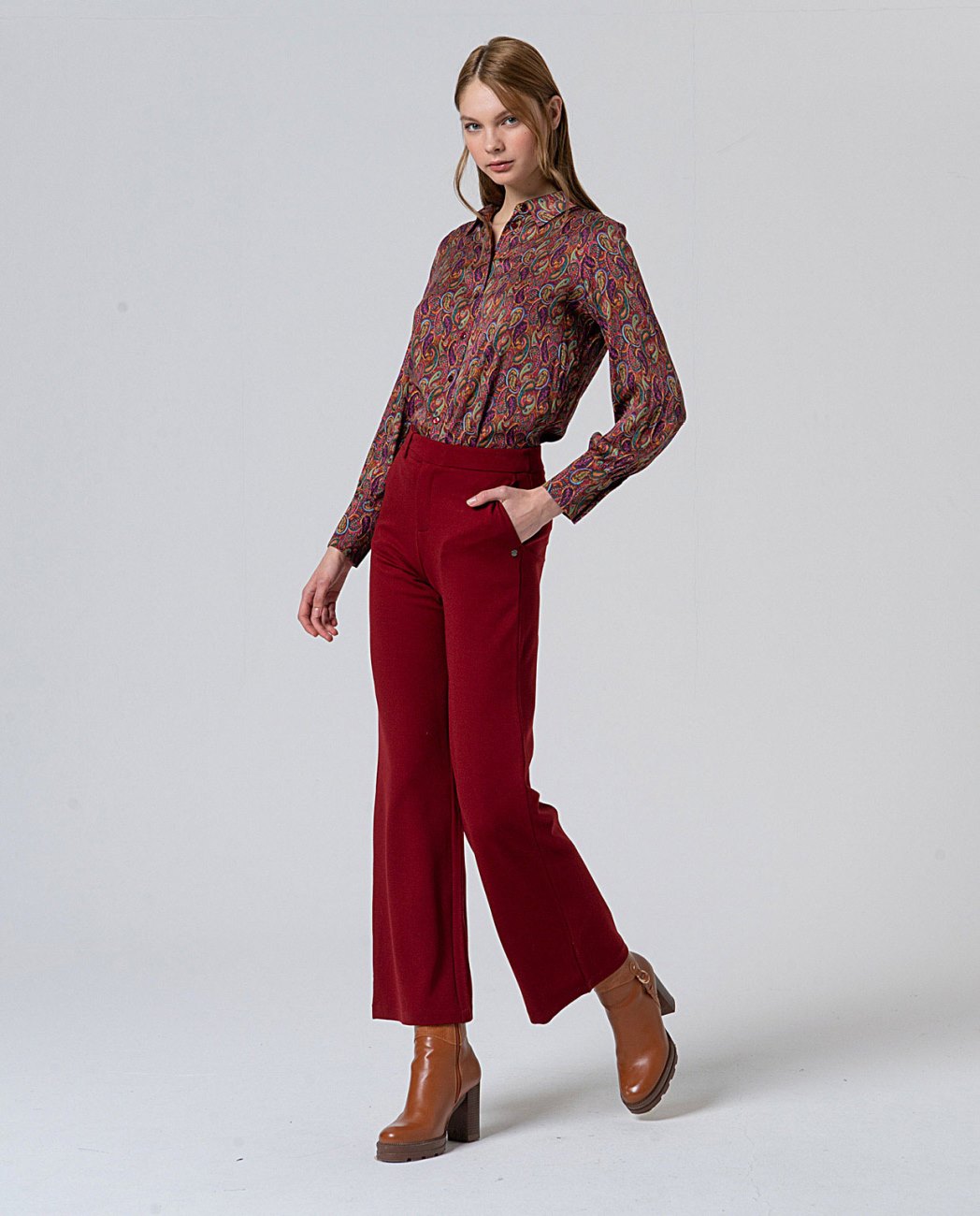 Straight red pants, with pockets and decorative button detail at the waist that mimics a belt, in 56%Rayon, 37%Nylon, 7%Spandex