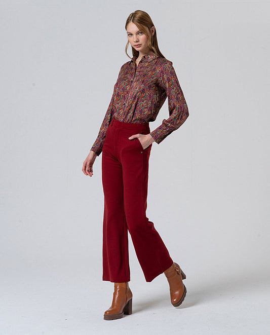 Straight red pants, with pockets and decorative button detail at the waist that mimics a belt, in 56%Rayon, 37%Nylon, 7%Spandex