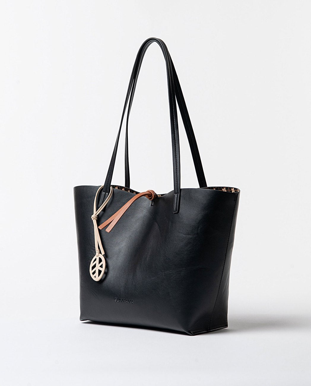 Large reversible faux leather shopper bag with printed toiletry bag, on one side, black color and on the other, an original print in black, camel, ecru colors.