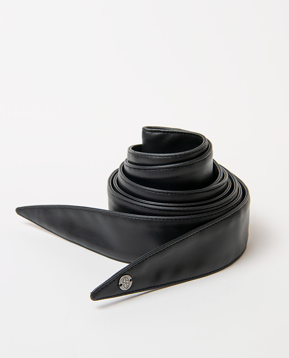 Sash-style black belt in smooth faux leather, wide and soft to the touch. Pointed ends that tie in a bow, no buckle, with a branded metal rivet.220cm long, 4,50 - 12,50cm wide
