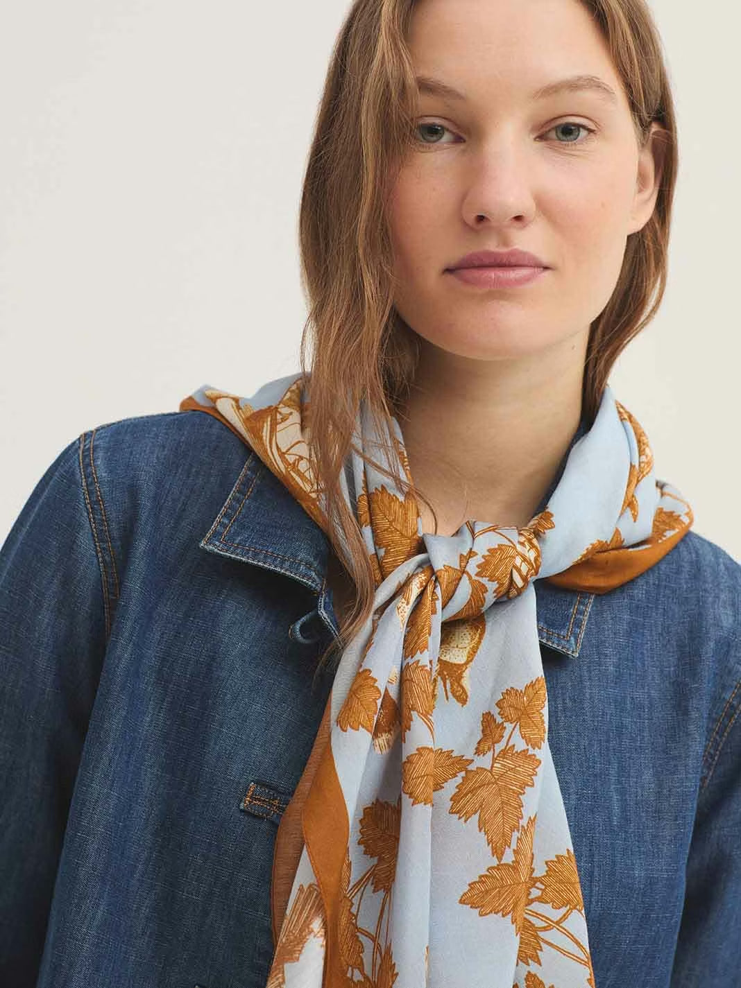 Light blue square scarf, digital printing with cinnamon leaves, books, fishes designs, 90 x 90 cm, 57 % Modal, 43% Cupro.