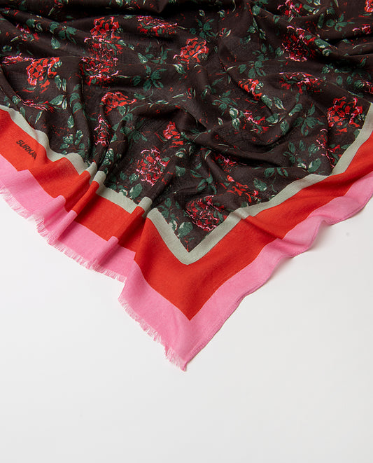 Rectangular chocolate scarf in light viscose with soft drape. Delicate pink, orange green roses print on a dark background, with a contrasting banded border and fringe.