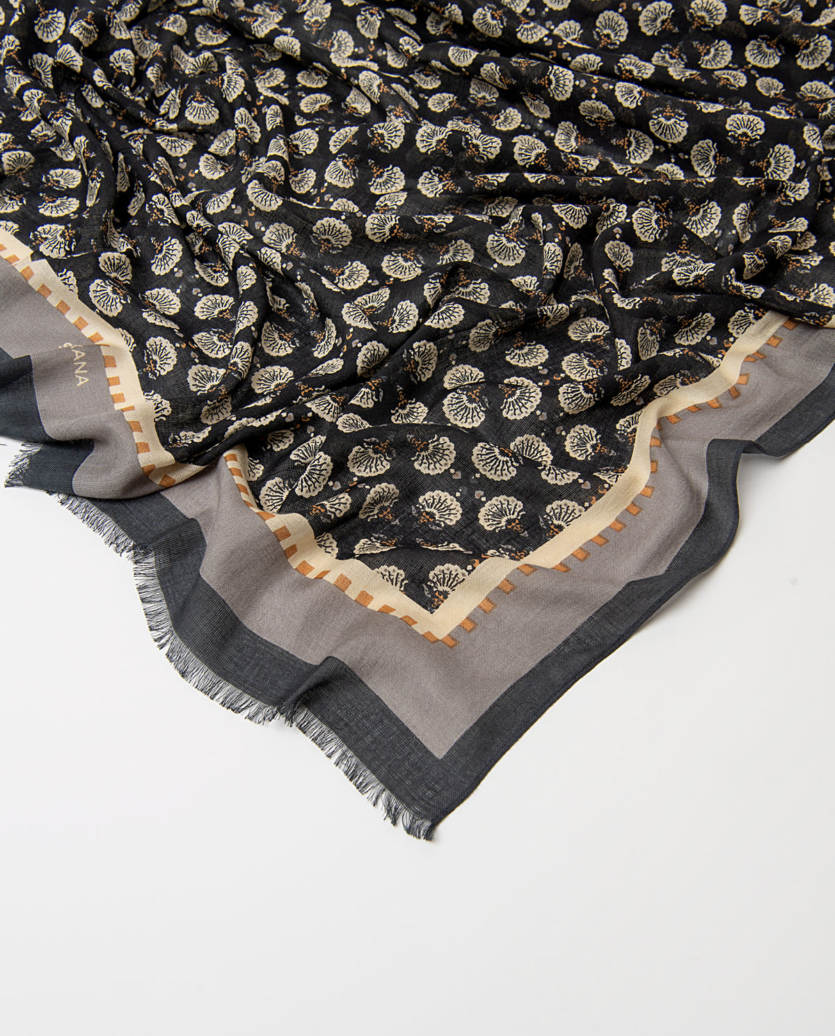 Rectangular black scarf in light viscose. Delicate ditsy floral print in ecru, grey, dark yellow colors, with an artisan feel, contrasting banded border and fringe.