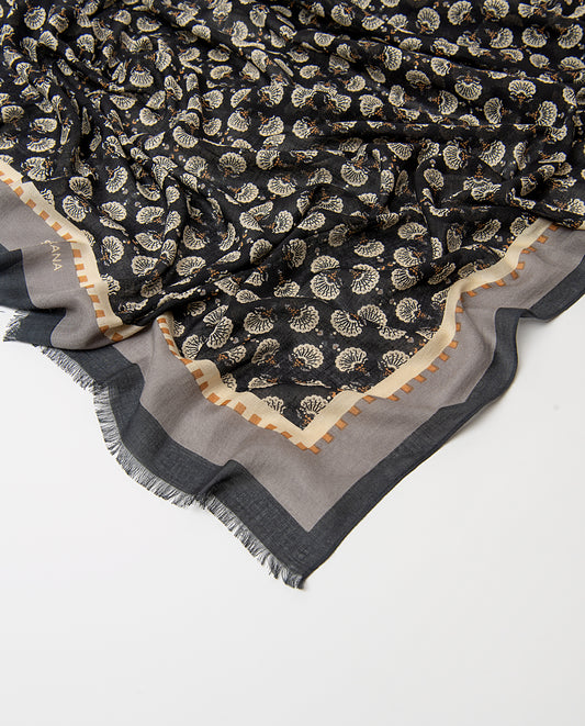 Rectangular black scarf in light viscose. Delicate ditsy floral print in ecru, grey, dark yellow colors, with an artisan feel, contrasting banded border and fringe.