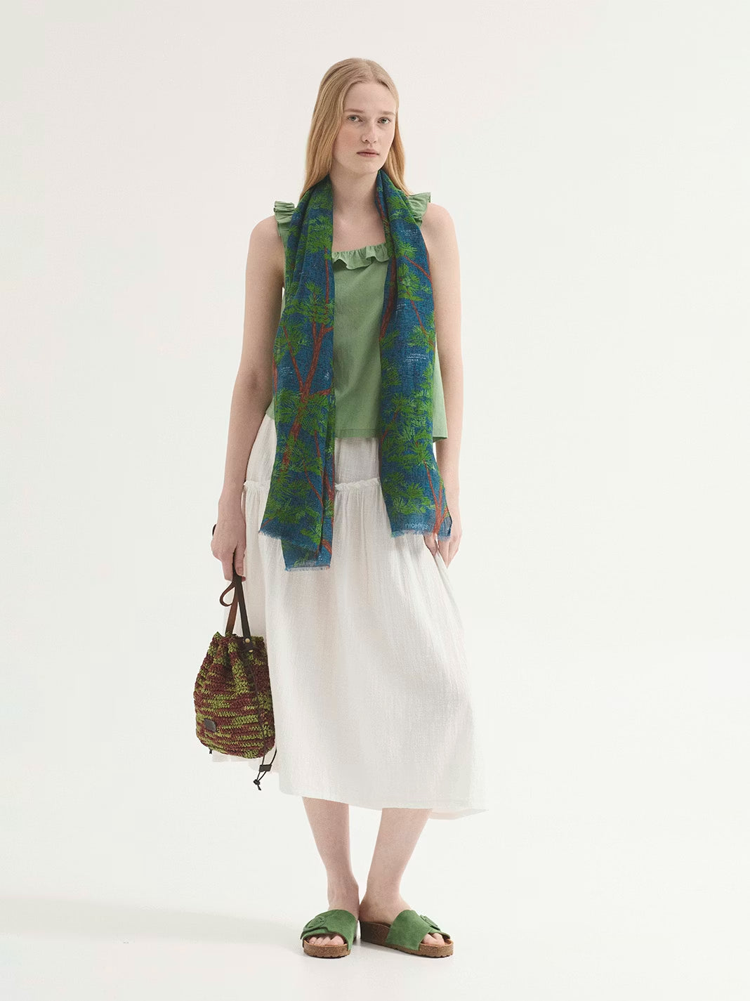 Rectangular print scarf in blue background color with brown and green pine trees designs, 67cm x 180cm, 75% cotton, 25% silk